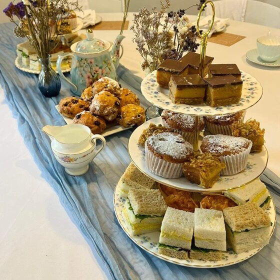Three tier cake stand with eats for a boy baby shower high tea party.