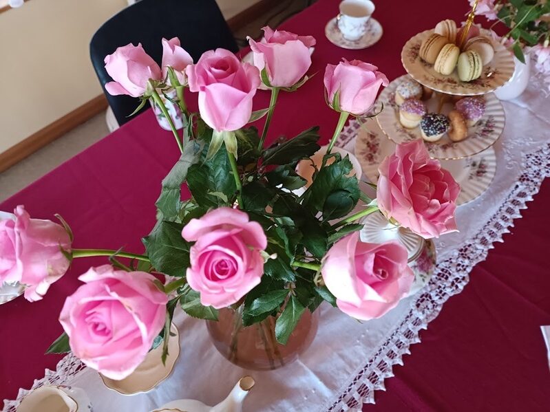 Vintage china tea sets with roses and three-tier cake stands for high tea events