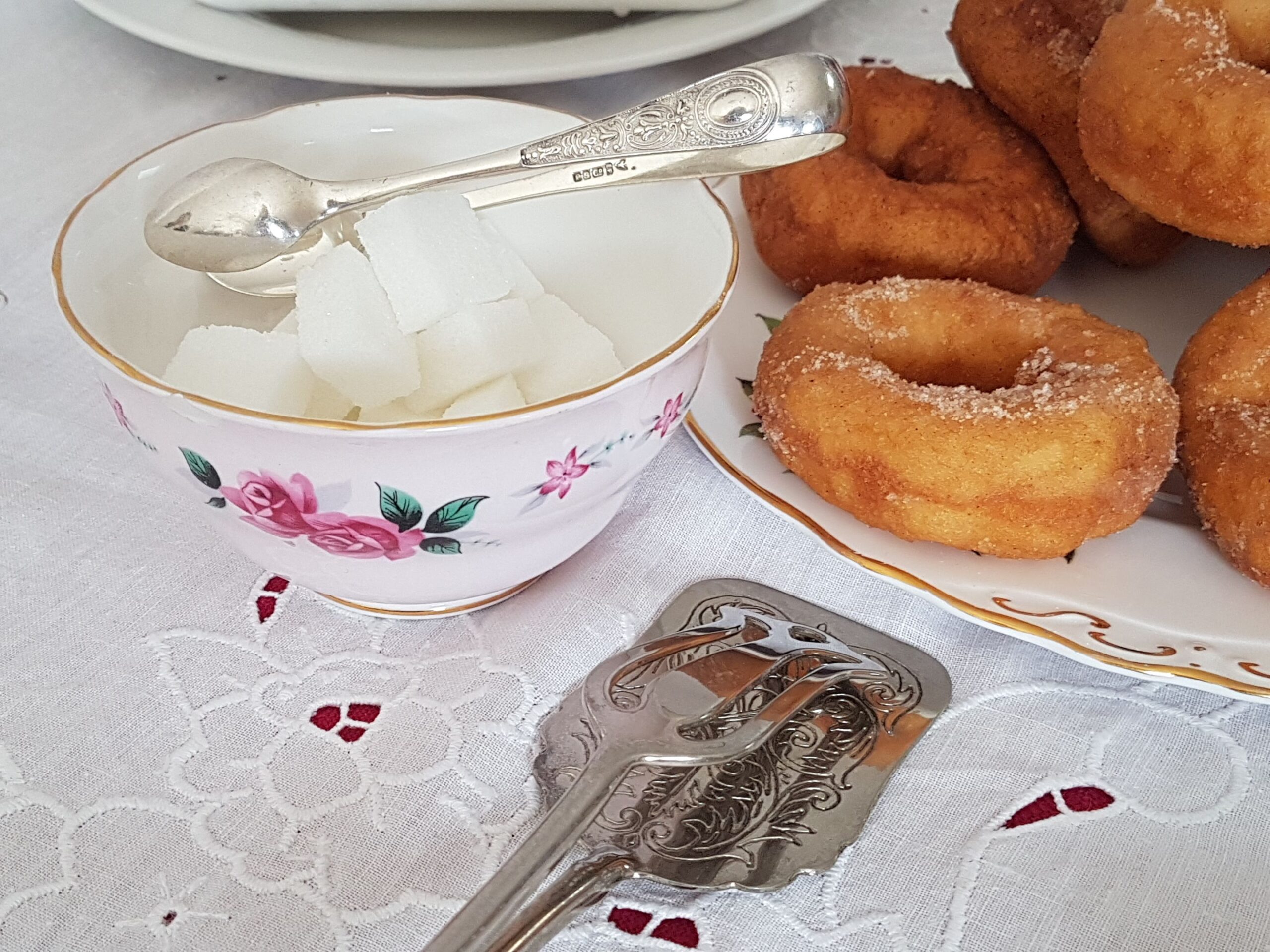 sugar bowl with silver sugar tongs and cake tongs